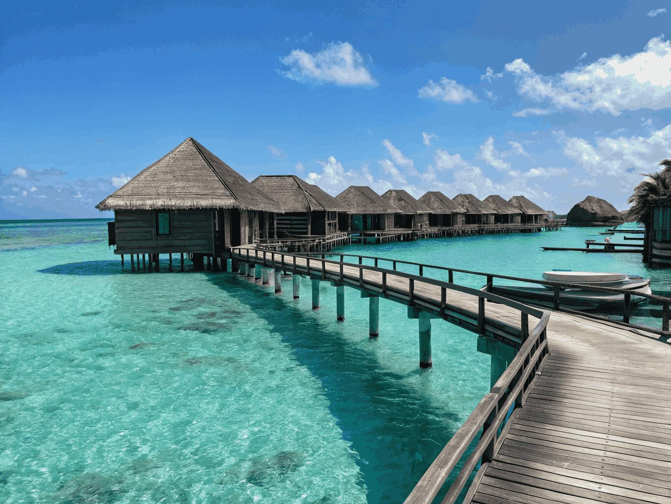 Island Resort Maldives — panoramic view of overwater bungalows and turquoise waters